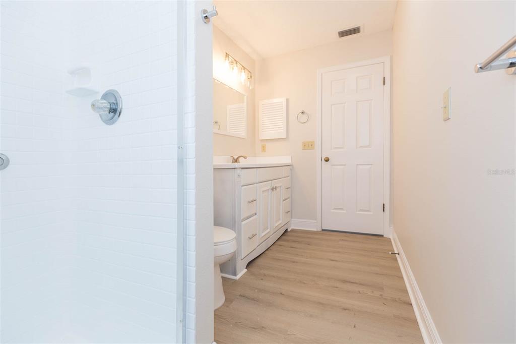 937 Bunker View Drive Apollo Beach, FL 33572 - Photo 42 of 73 a bathroom with a granite countertop sink a toilet and a mirror