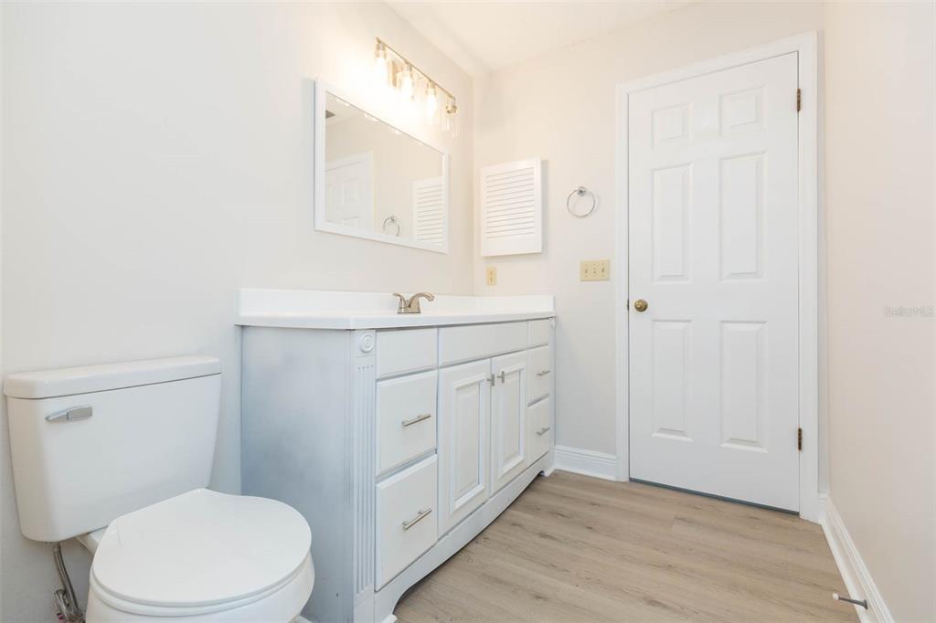 937 Bunker View Drive Apollo Beach, FL 33572 - Photo 43 of 73 a bathroom with a toilet a sink a mirror and vanity