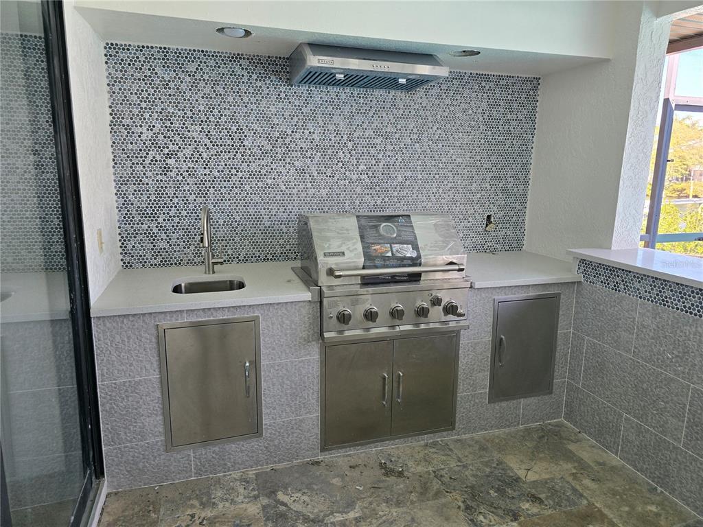 937 Bunker View Drive Apollo Beach, FL 33572 - Photo 47 of 73 a kitchen with a stove and a refrigerator