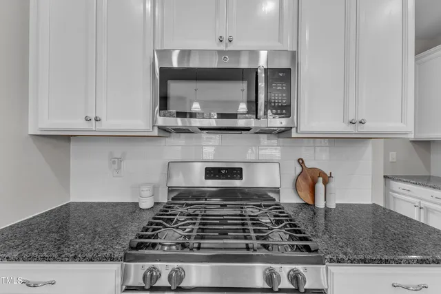 a kitchen with stainless steel appliances granite countertop a sink and a granite counter tops