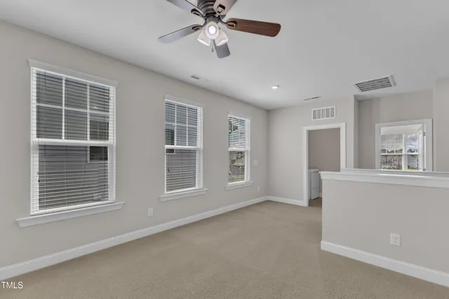 an empty room with a empty space and windows