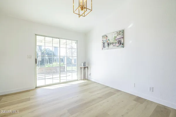 a view of open kitchen with wooden floor and electronic appliances