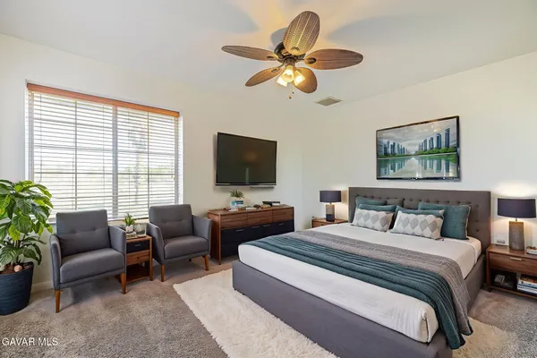 a view of a room with a ceiling fan and a window