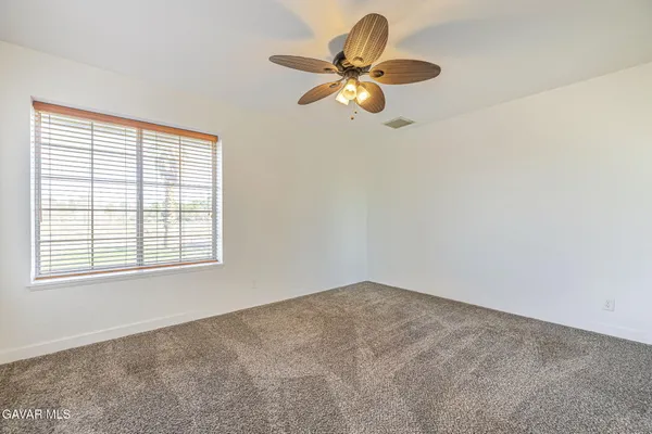 an empty room with closet and windows