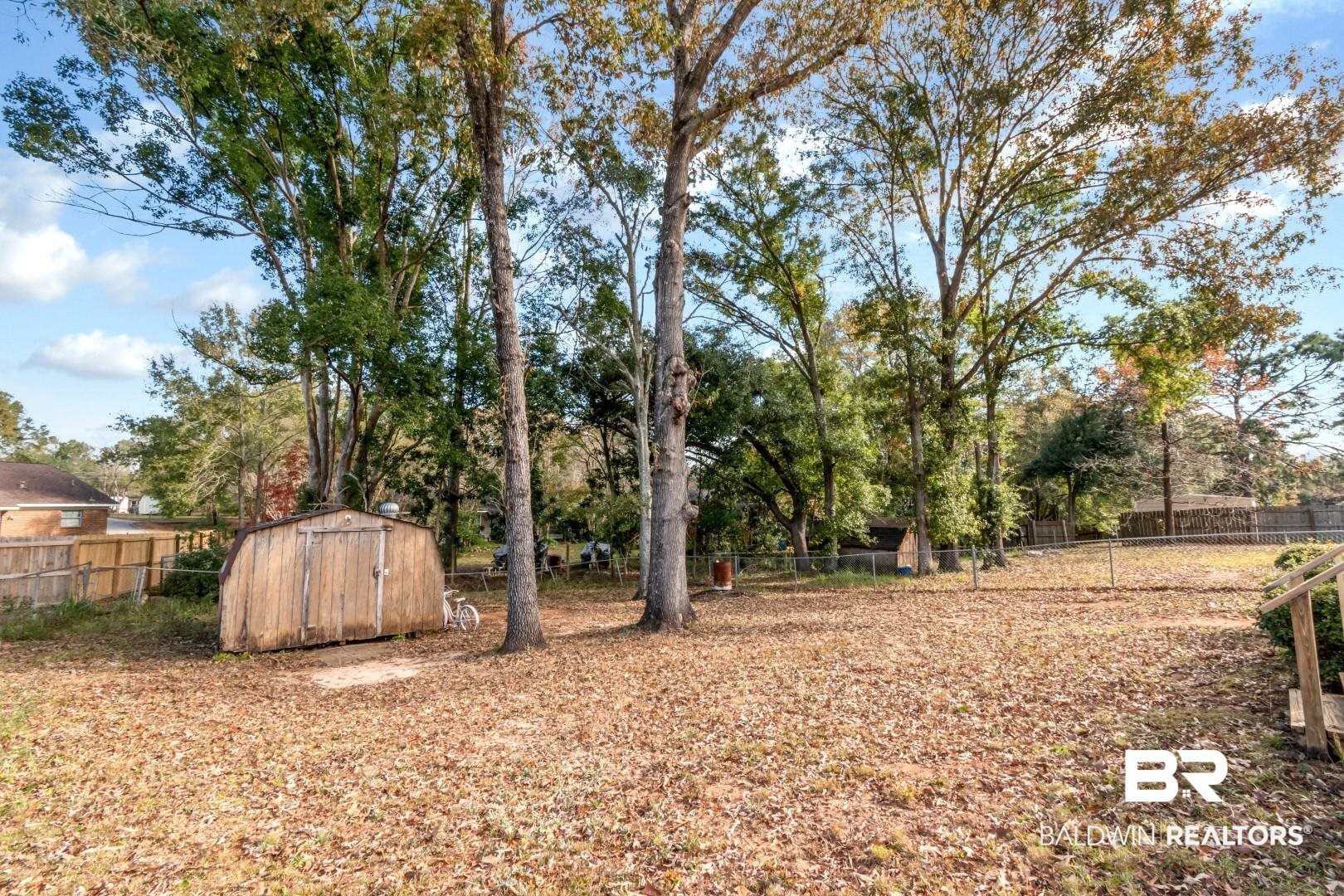 9360 Burnt Tree Drive Mobile, AL 36695 - Photo 26 of 28 View of yard featuring a storage shed