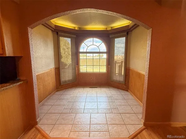a view of an empty room with a fireplace and a window