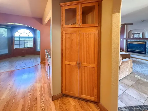 a living room with furniture a ceiling fan and a window