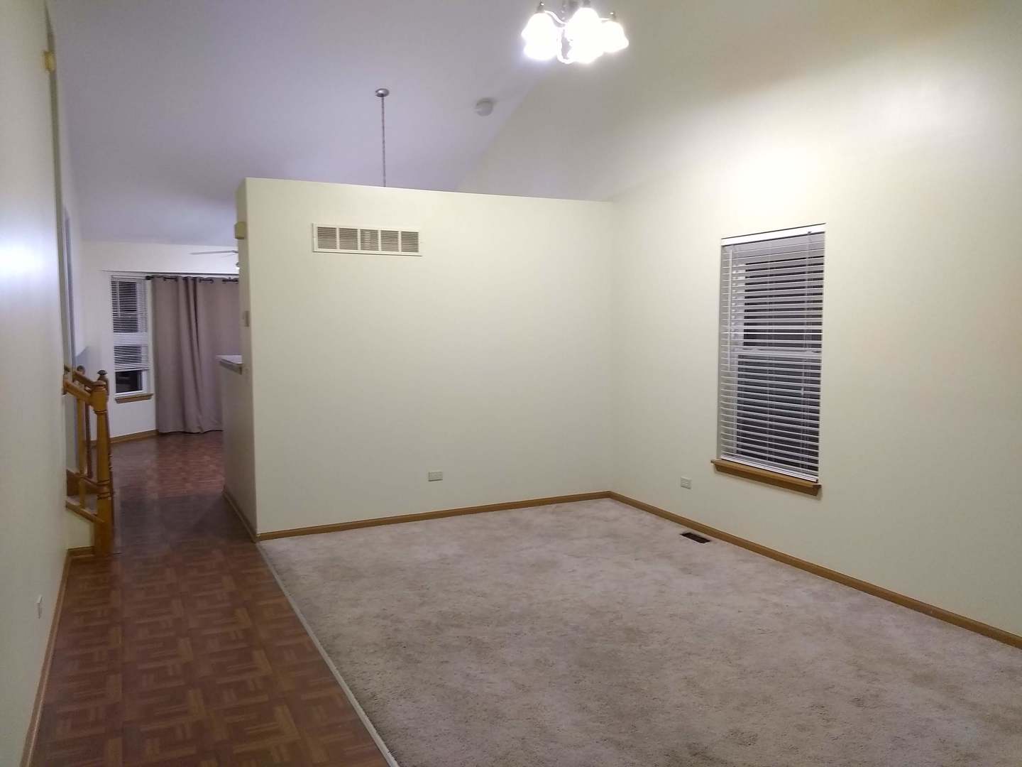 2103 Beldon Court Plainfield, IL 60586 - Photo 3 of 16 a view of a hallway with wooden floor and a kitchen