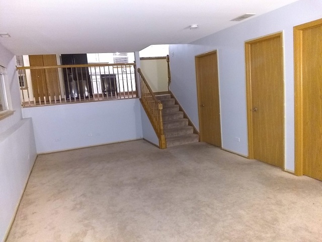 2103 Beldon Court Plainfield, IL 60586 - Photo 6 of 16 a view of an empty room with windows