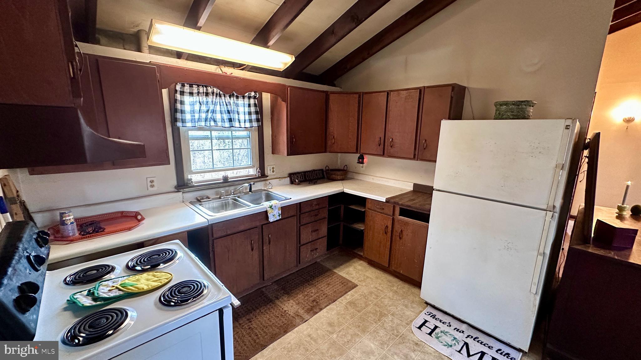 1336 Old Winchester Road Boyce, VA 22620 - Photo 8 of 76 a kitchen with a refrigerator a stove a sink and a window