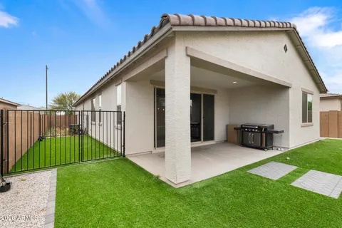 a view of an house with backyard and porch