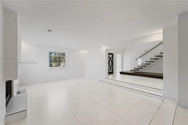 a view of empty room with a fireplace
