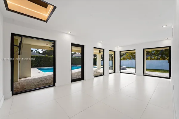 a view of an empty room with glass door