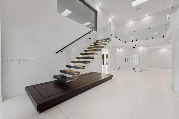 a kitchen with stainless steel appliances kitchen island granite countertop a refrigerator and a sink