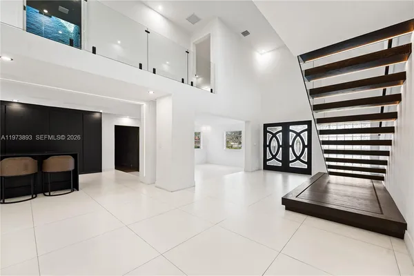 a bathroom with a shower sink and mirror