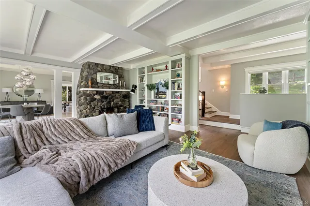 a living room with furniture a rug and a window