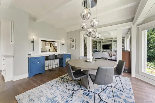 a view of a dining room with furniture window and wooden floor