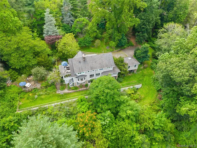 an aerial view of a house with yard
