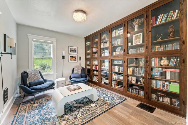 a living room with furniture and a book shelf