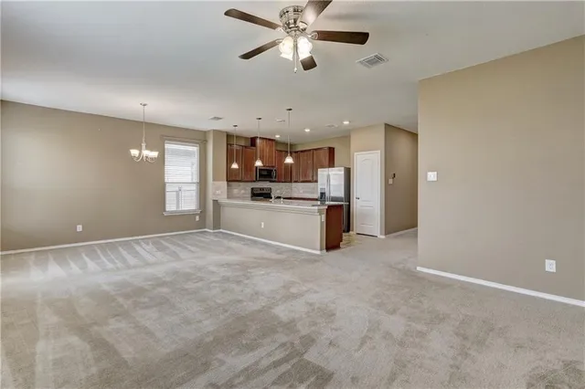 a view of a kitchen with a sink and a stove top oven