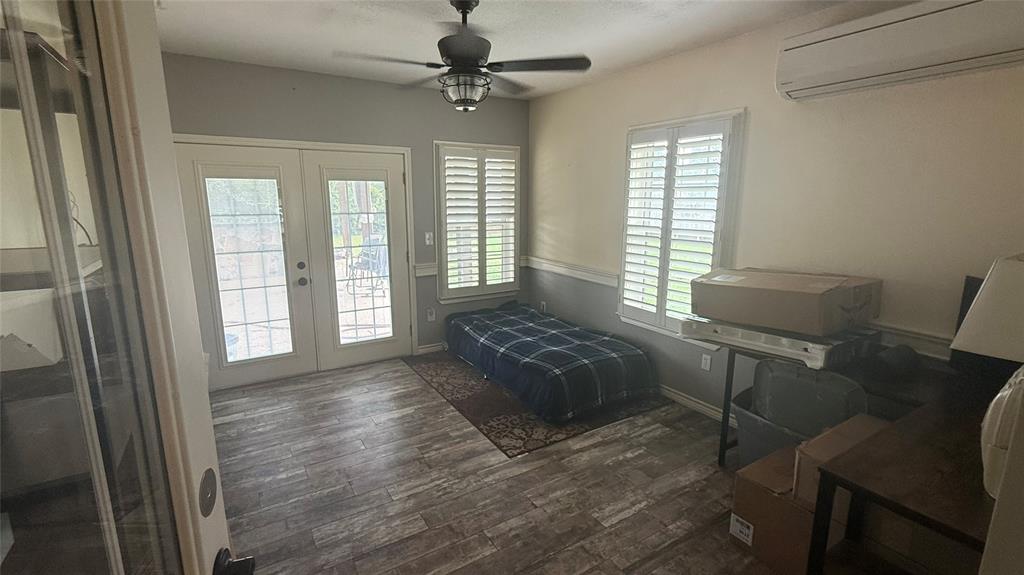 1356 Kerry Lane Azle, TX 76020 - Photo 18 of 27 Room featuring wood-look tile flooring, white French doors, and two windows with white plantation shutters