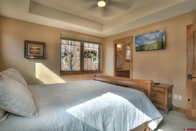 a bedroom with a large bed and a walk in closet