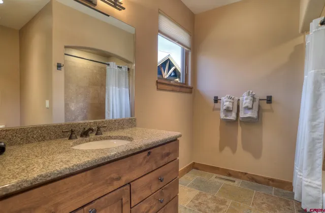 a furnished livingroom with wooden floor and stairs
