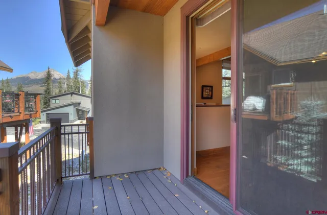 a large kitchen with stainless steel appliances wooden floor and a large window