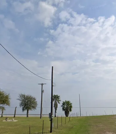 a view of a swimming pool with a yard