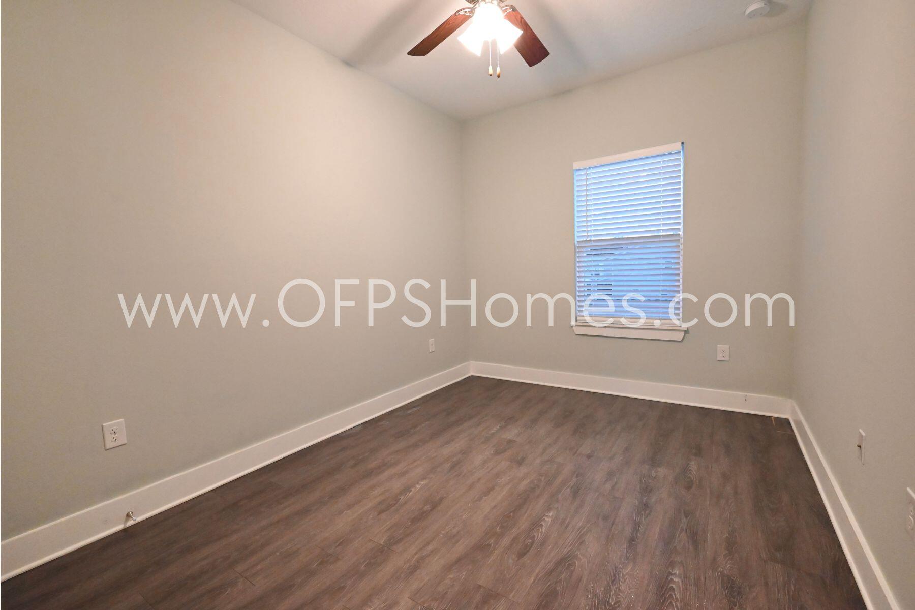 312 North Sand Palm Road Freeport, FL 32439 - Photo 12 of 26 an empty room with wooden floor