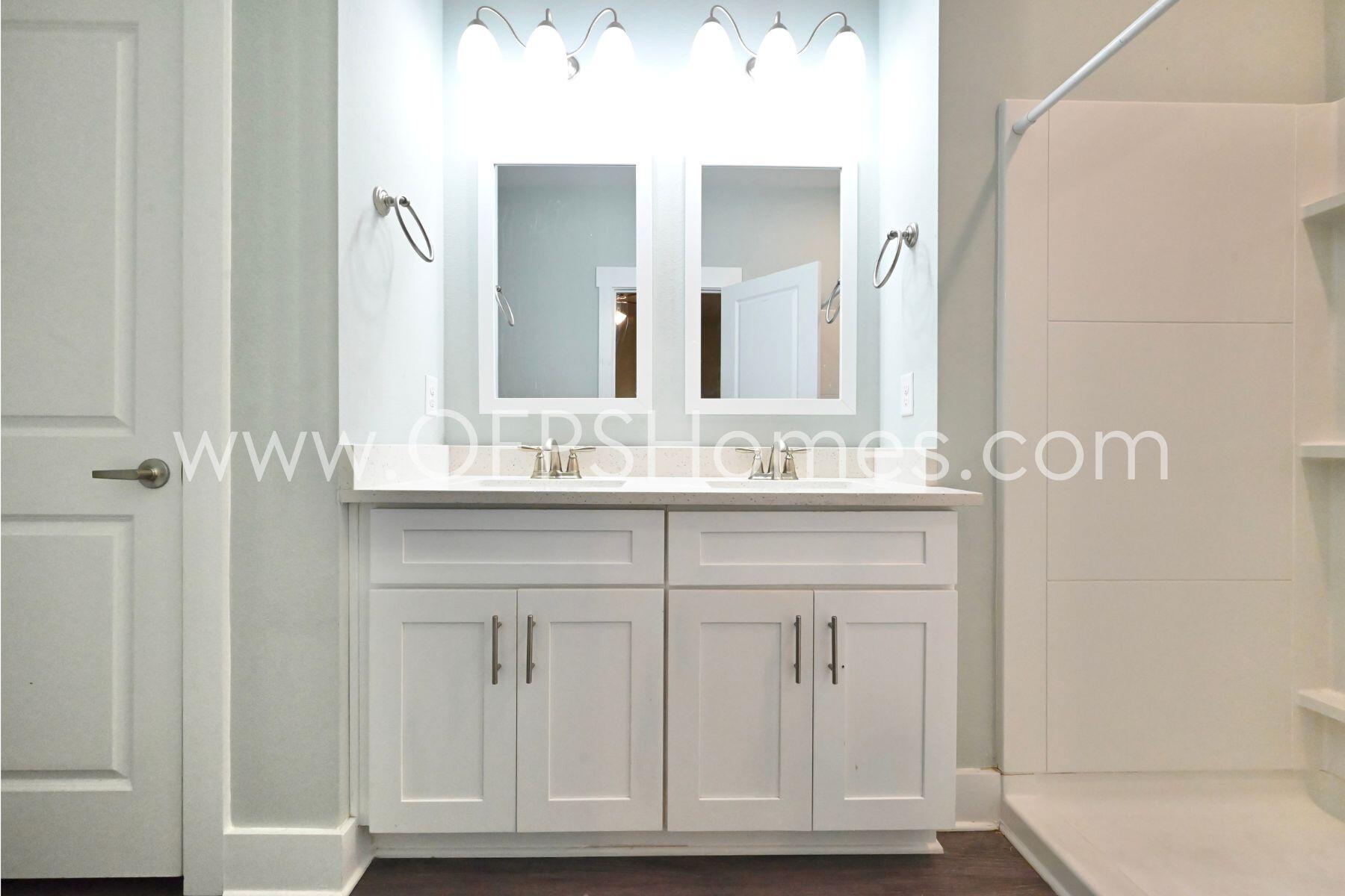 312 North Sand Palm Road Freeport, FL 32439 - Photo 16 of 26 a bathroom with cabinets a sink and a mirror