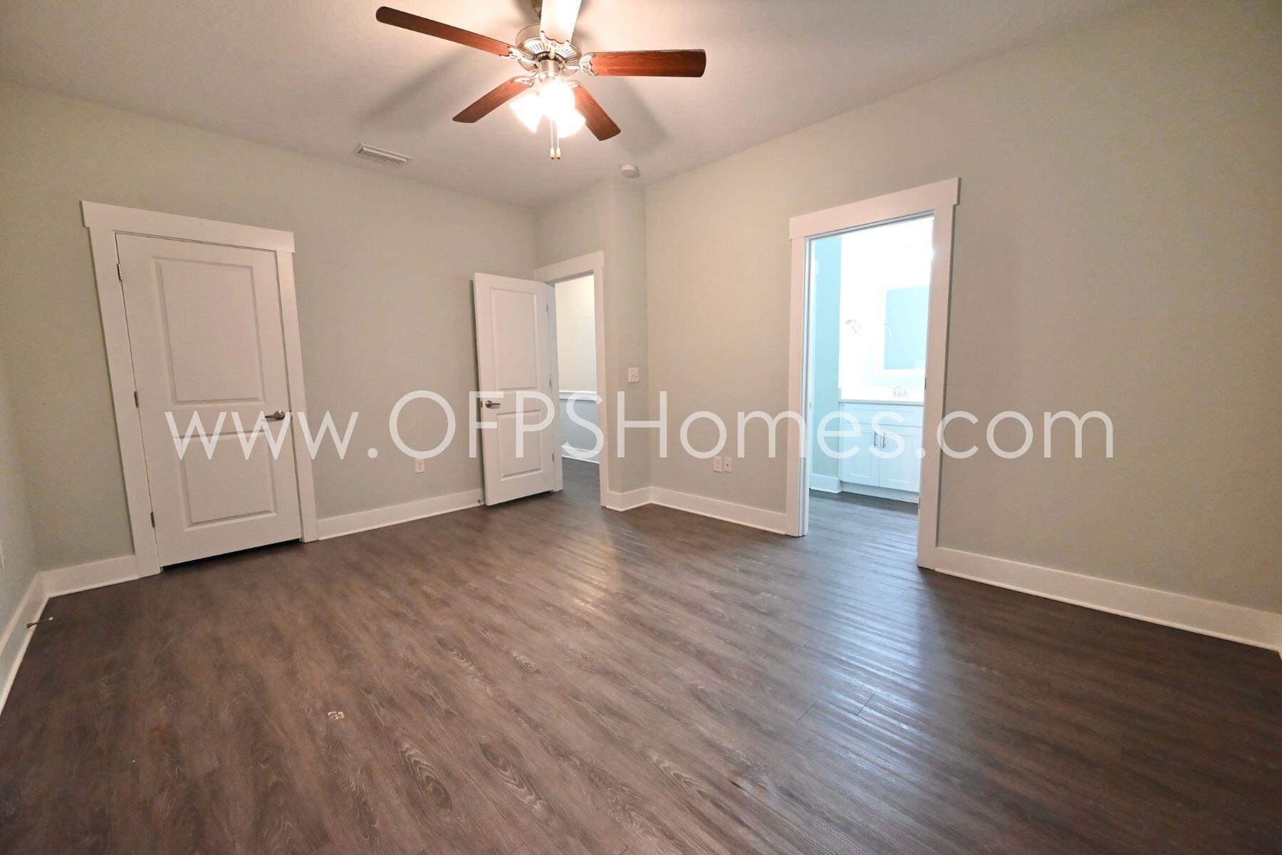 312 North Sand Palm Road Freeport, FL 32439 - Photo 18 of 26 a view of an empty room with window hardwood floor and cabinet
