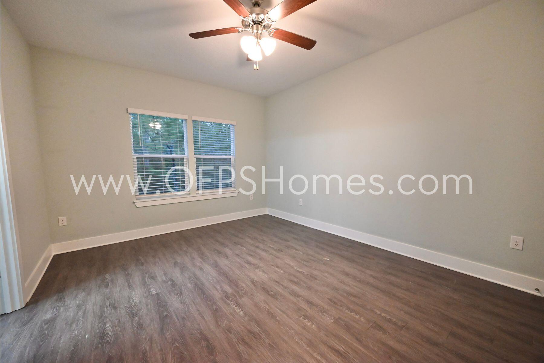 312 North Sand Palm Road Freeport, FL 32439 - Photo 19 of 26 an empty room with wooden floor and windows
