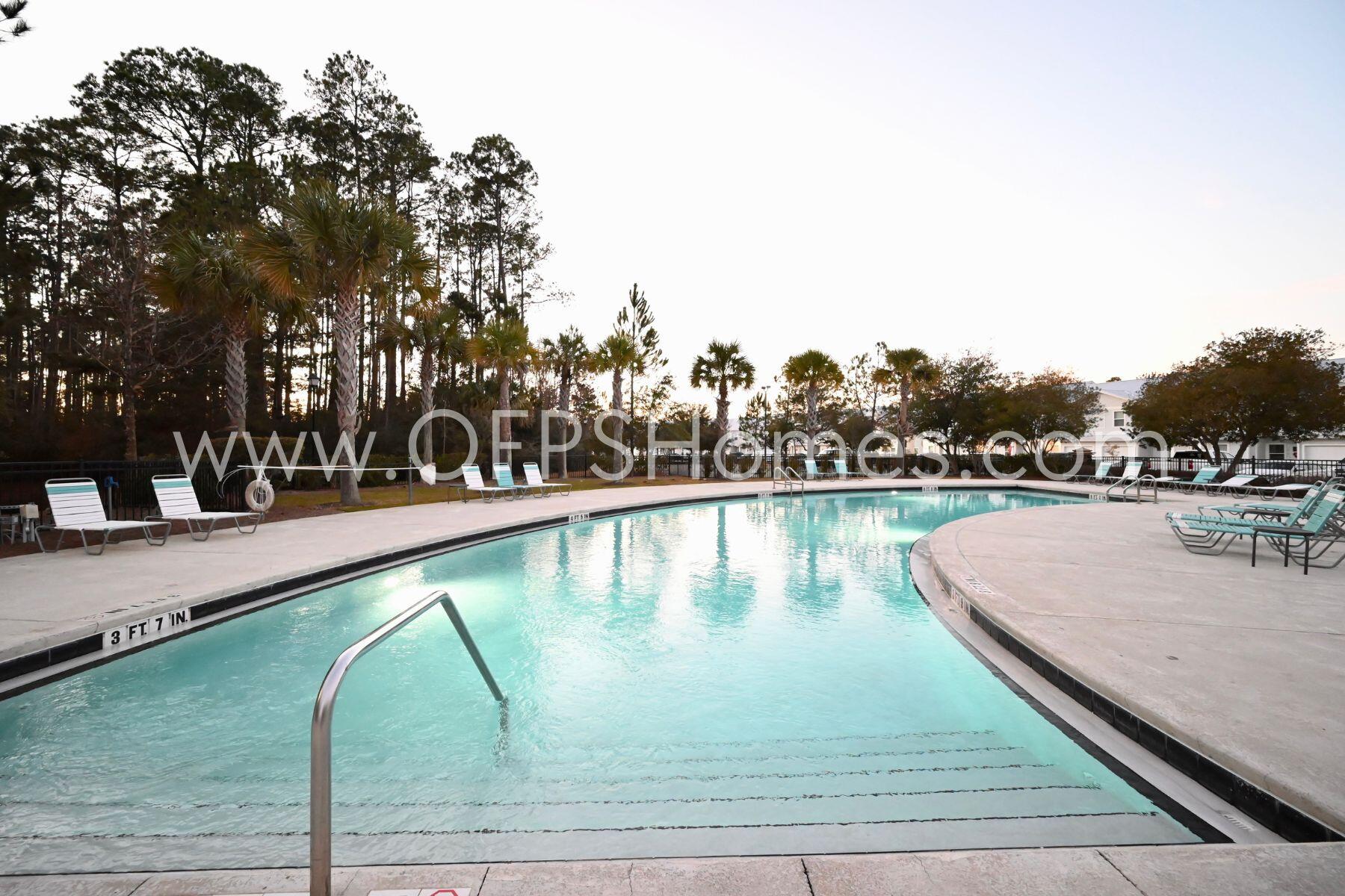312 North Sand Palm Road Freeport, FL 32439 - Photo 25 of 26 a view of swimming pool with outdoor seating and lake view