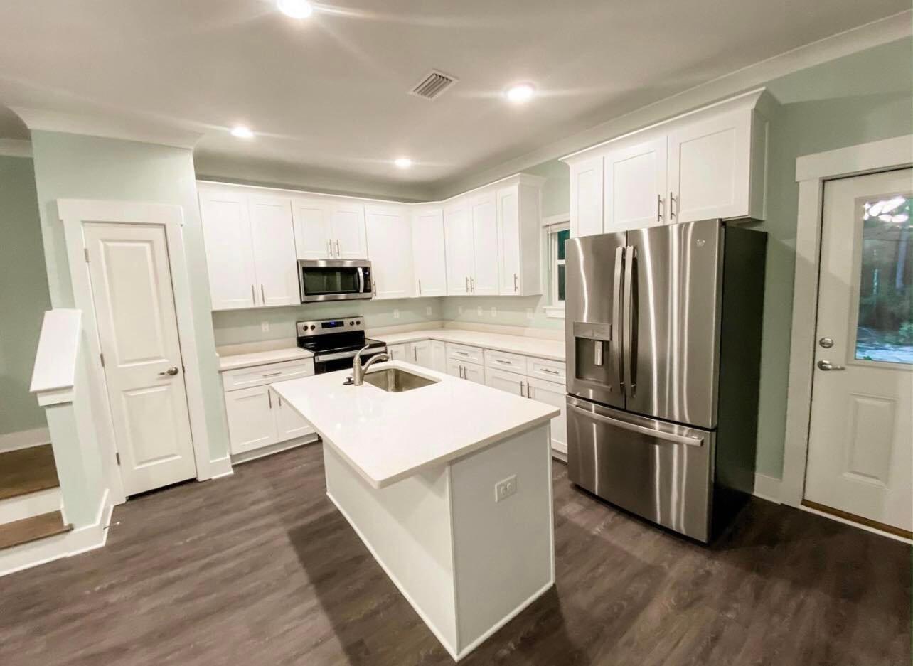 312 North Sand Palm Road Freeport, FL 32439 - Photo 3 of 26 a kitchen with stainless steel appliances a refrigerator stove microwave and sink