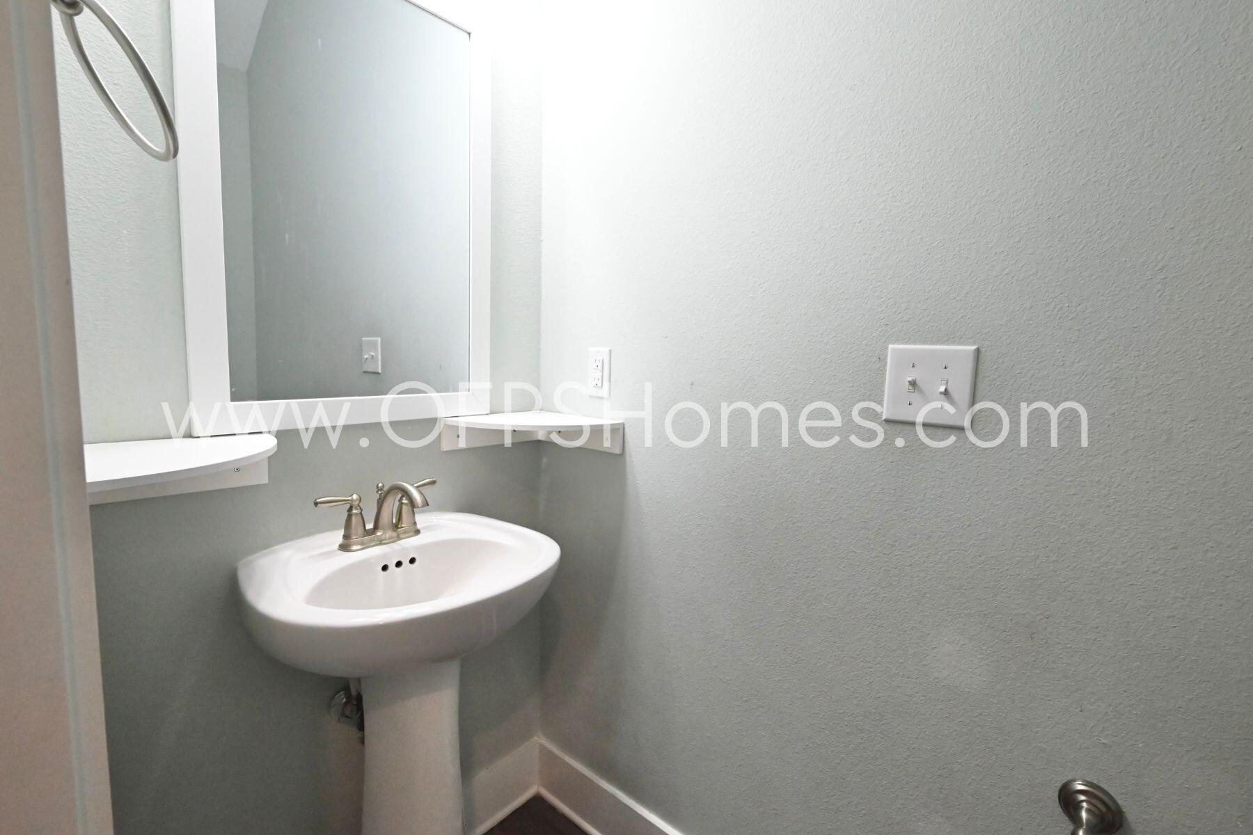 312 North Sand Palm Road Freeport, FL 32439 - Photo 4 of 26 a bathroom with a sink and mirror