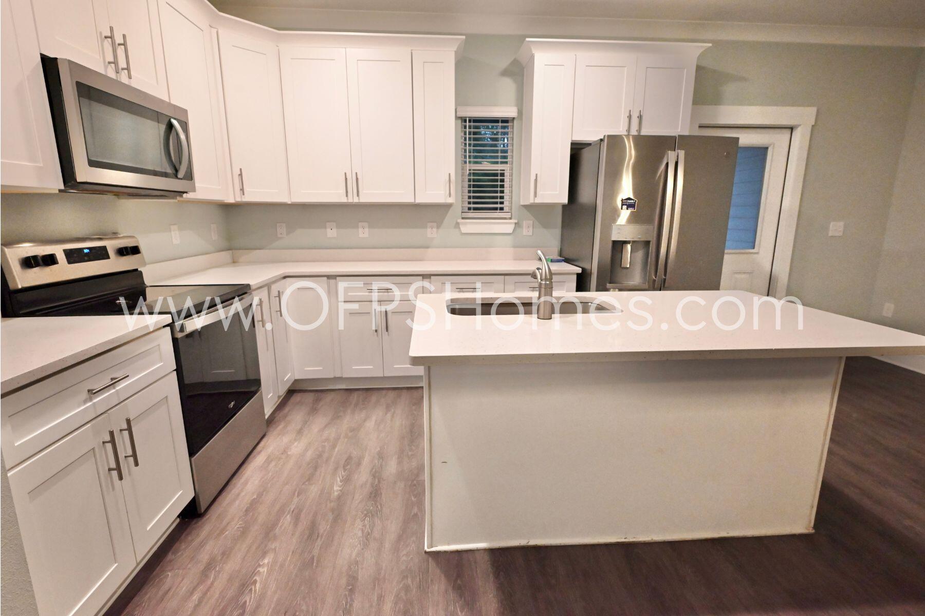 312 North Sand Palm Road Freeport, FL 32439 - Photo 7 of 26 a kitchen with stainless steel appliances a refrigerator stove and sink