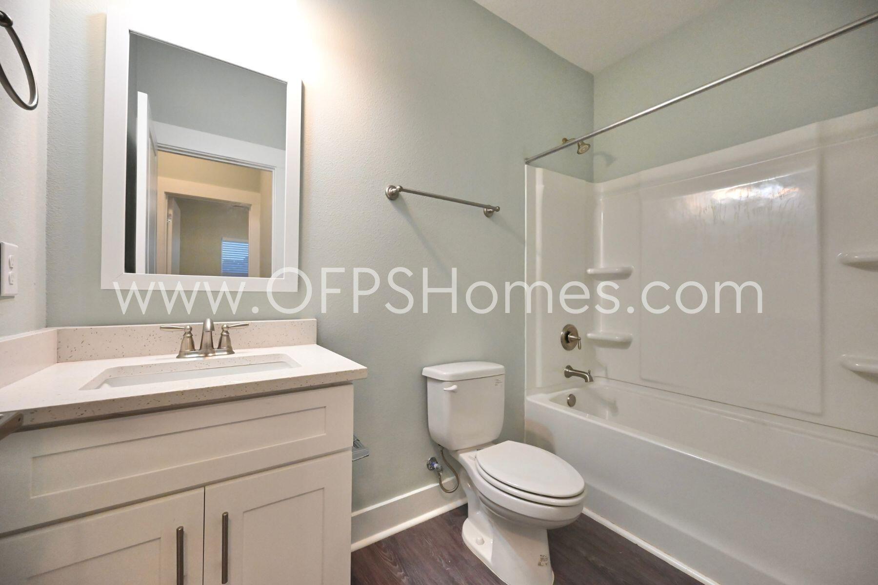 312 North Sand Palm Road Freeport, FL 32439 - Photo 10 of 26 a bathroom with a sink a toilet and shower