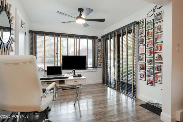 a dining hall with granite countertop a sink cabinets and wooden floor