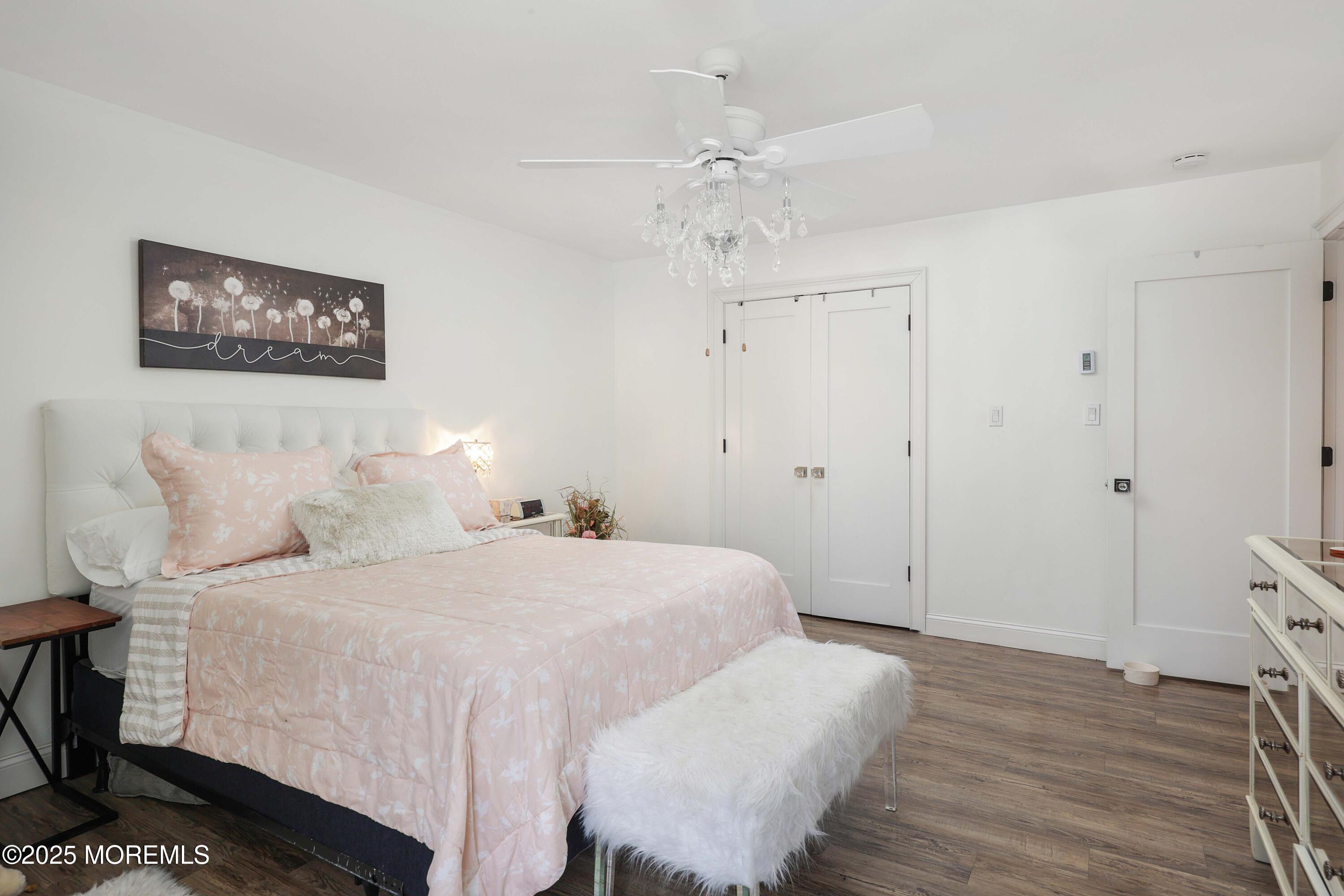 126 Manchester Court Red Bank, NJ 07701 - Photo 12 of 22 a bedroom with a bed and a chandelier