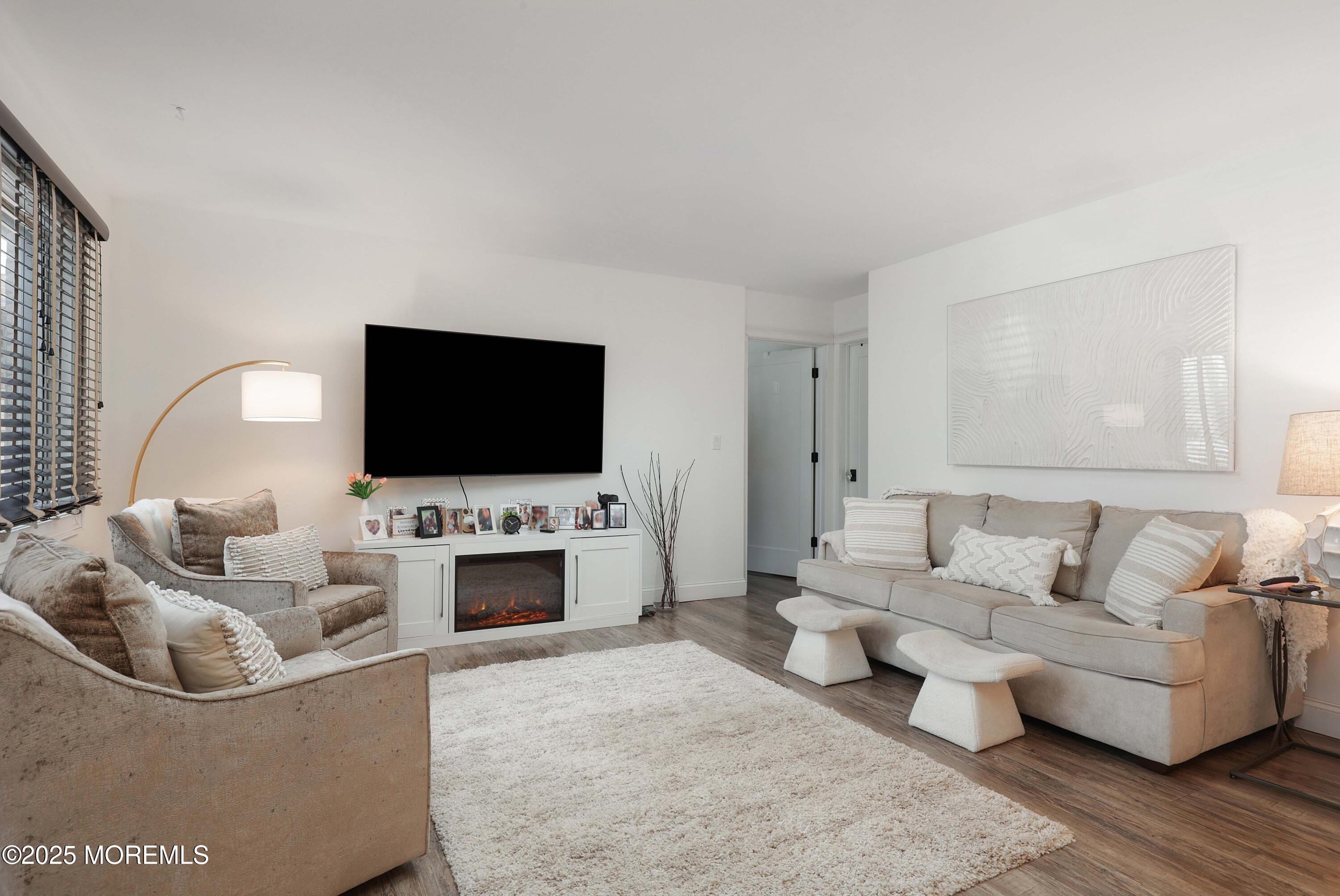 126 Manchester Court Red Bank, NJ 07701 - Photo 2 of 22 a living room with furniture and a flat screen tv