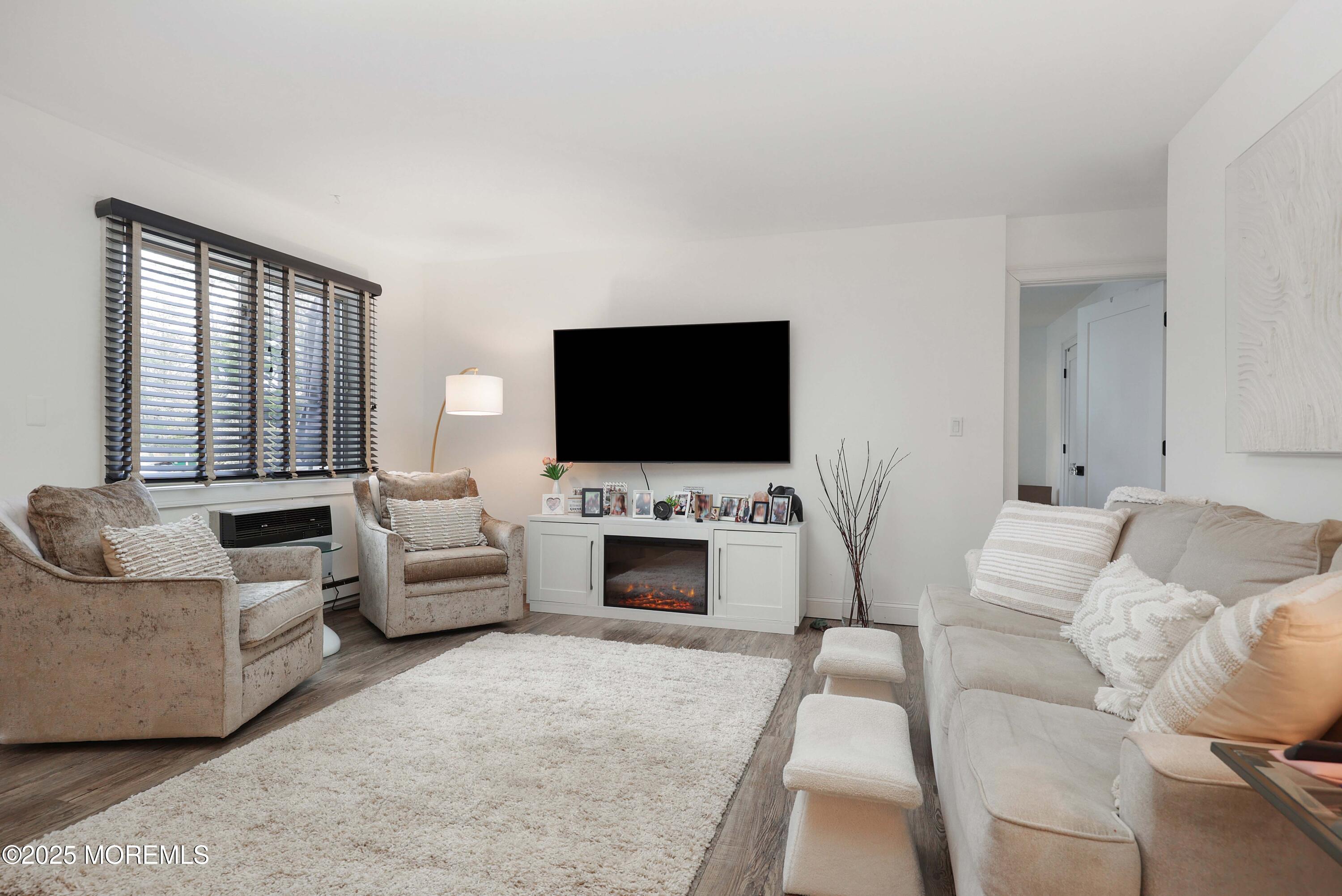 126 Manchester Court Red Bank, NJ 07701 - Photo 4 of 22 a living room with furniture and a flat screen tv