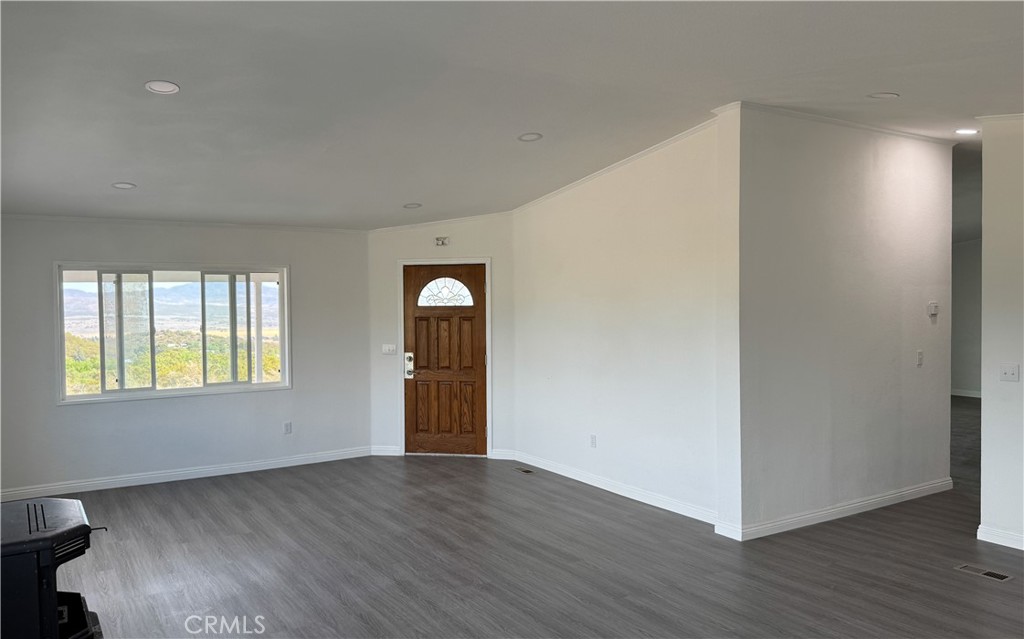 56515 Dickson Way Anza, CA 92539 - Photo 11 of 17 a view of an empty room with wooden floor and a window