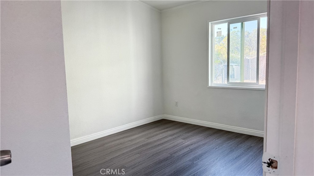 56515 Dickson Way Anza, CA 92539 - Photo 12 of 17 an empty room with wooden floor and windows