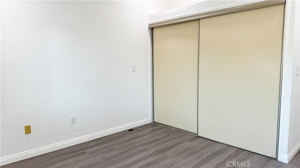 56515 Dickson Way Anza, CA 92539 - Photo 15 of 17 a view of an empty room with wooden floor and a window