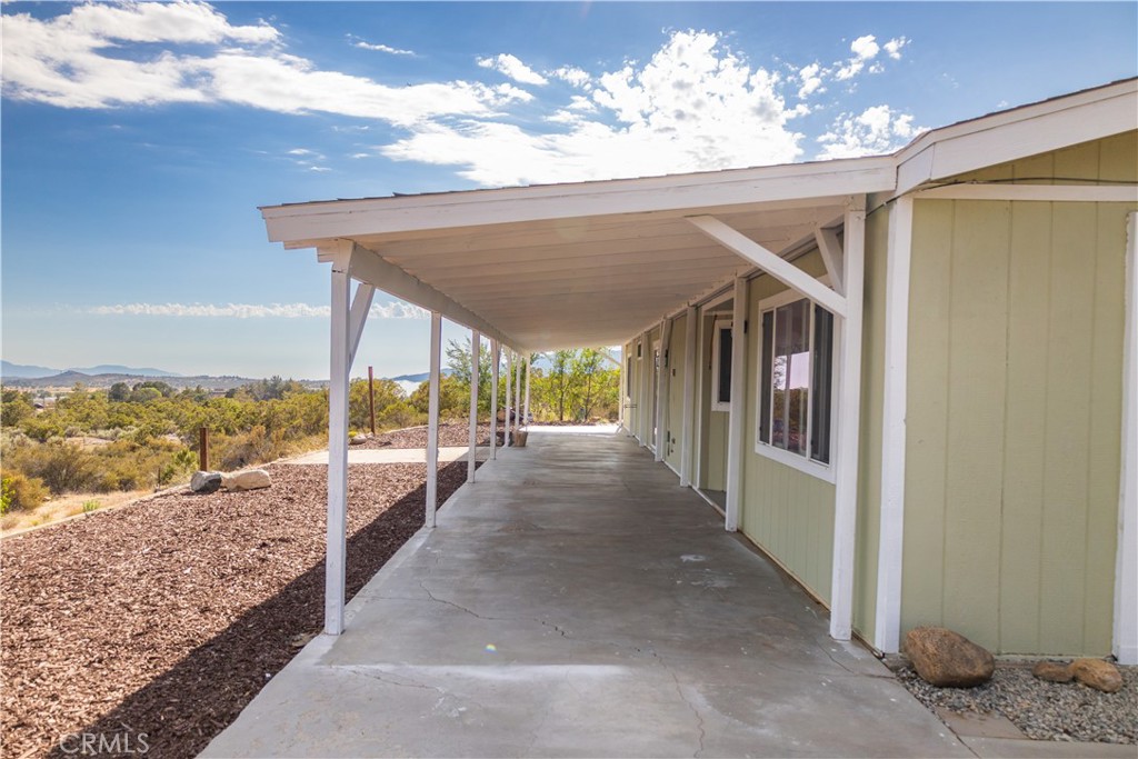 56515 Dickson Way Anza, CA 92539 - Photo 2 of 17 a view of a porch with furniture and floor to ceiling window