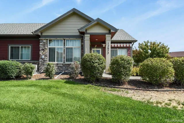 a front view of a house with a yard and porch