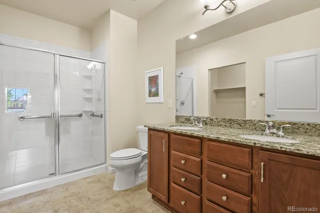 a bathroom with a granite countertop sink toilet and shower