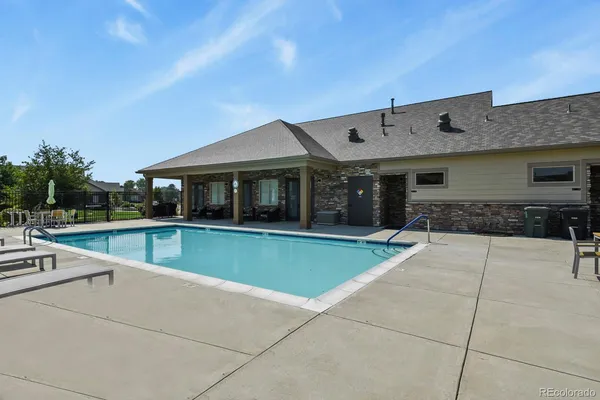 a view of a dining room with furniture a chandelier and a rug
