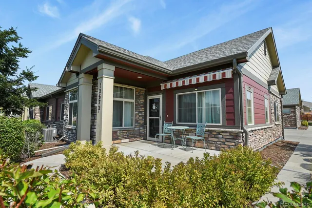 a front view of a house with a garden and plants